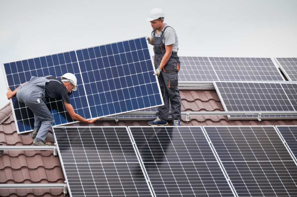 Technicians installing solar panels 