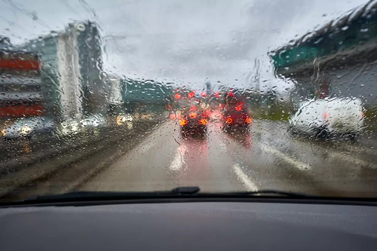 A window with the view blurred by rainwater.