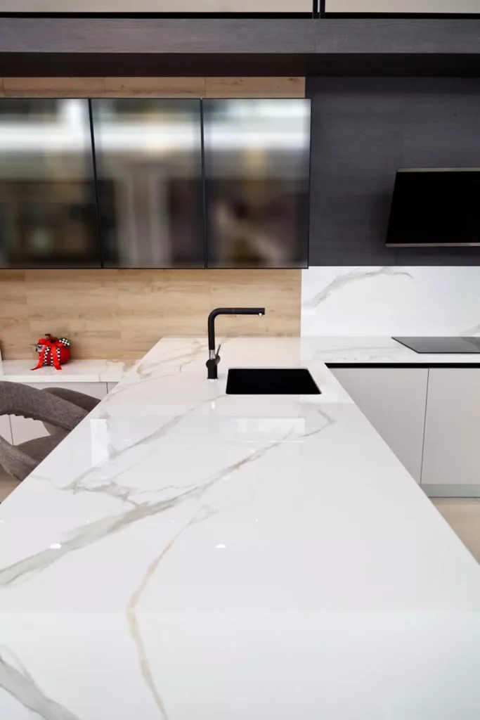modern-white-lacquer-ash-tree-wood A long white granite countertop with a sink.