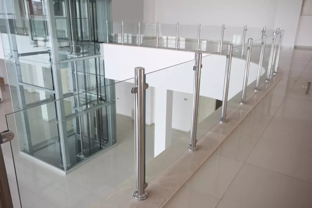 A glass railing on the second floor of a building.